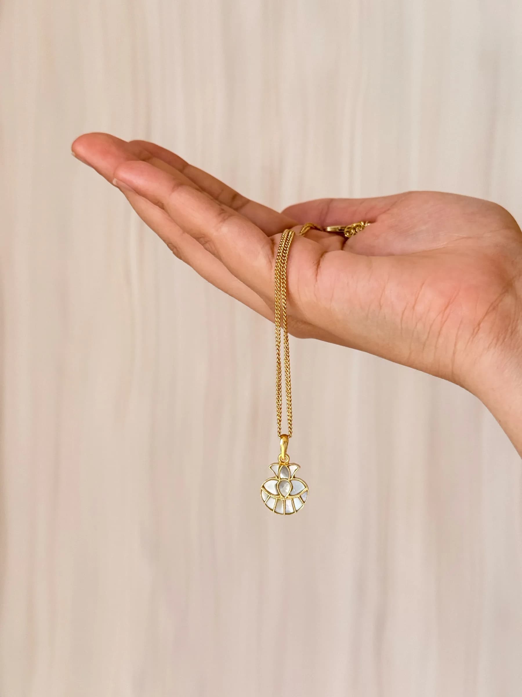 Kalāsh Pendant – worn close-up